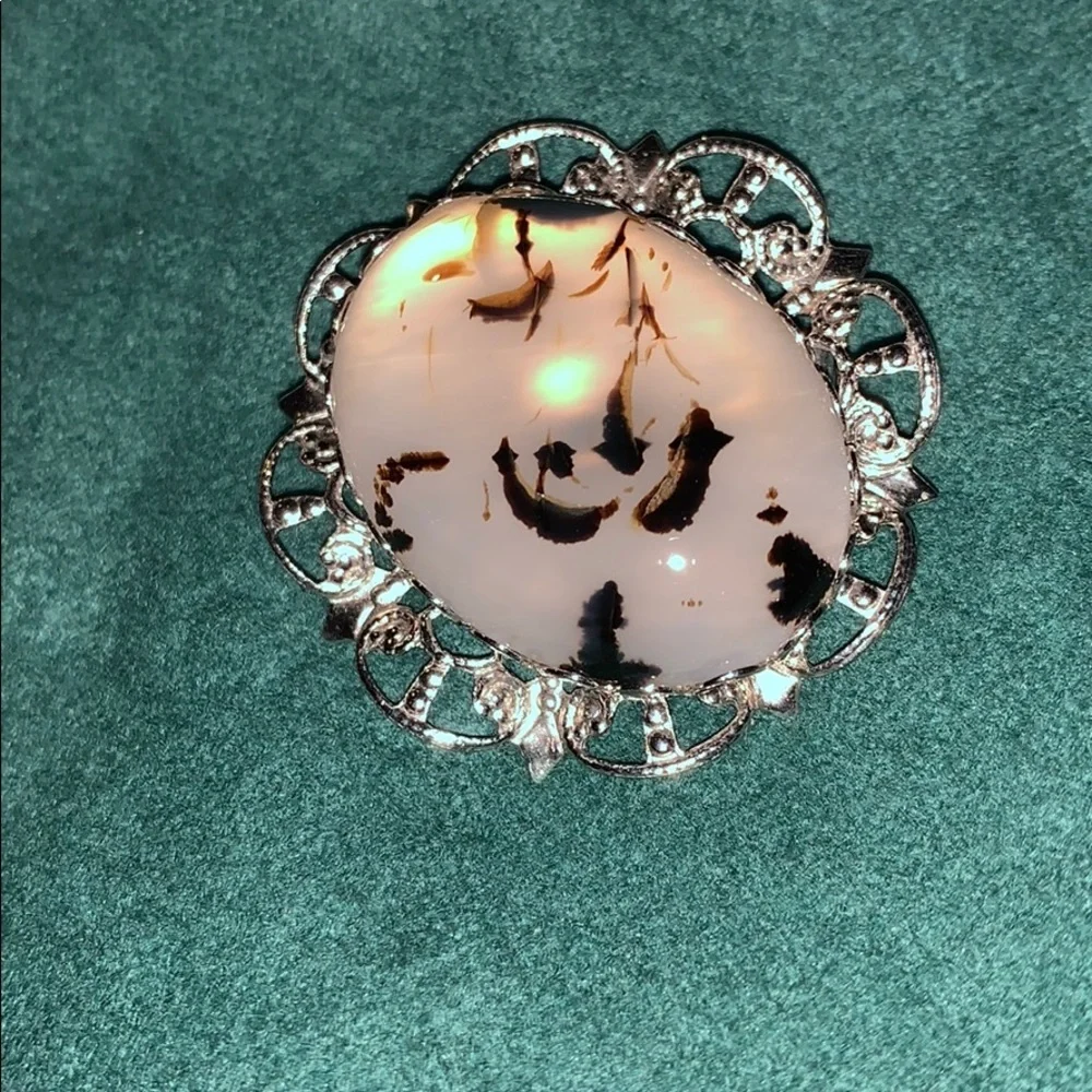 Translucent w/ black accents stone in a silver pin